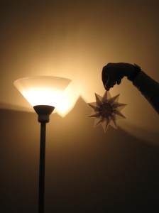 An interlocking origami star illuminated.